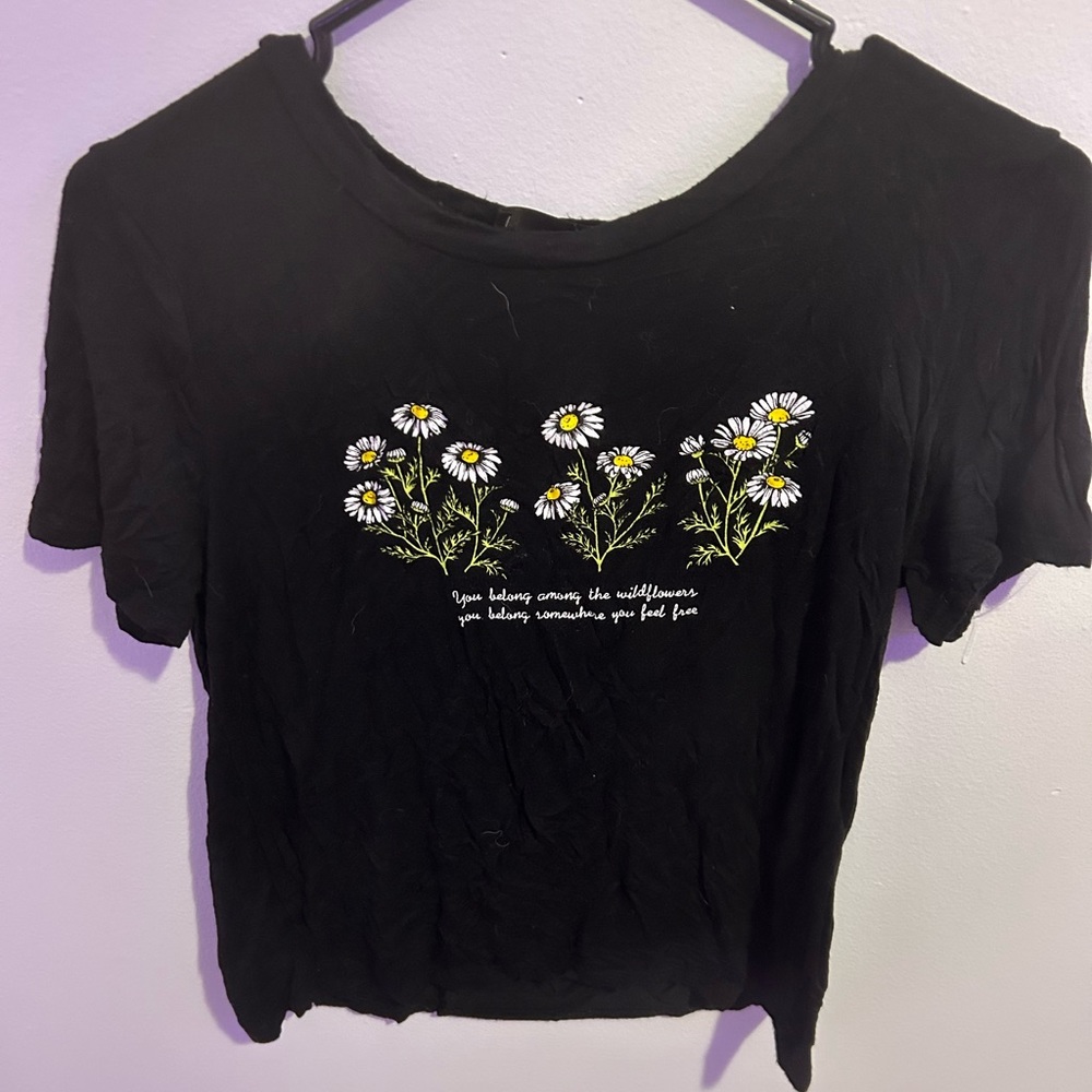 super soft black tee with daisys on the front and a quote